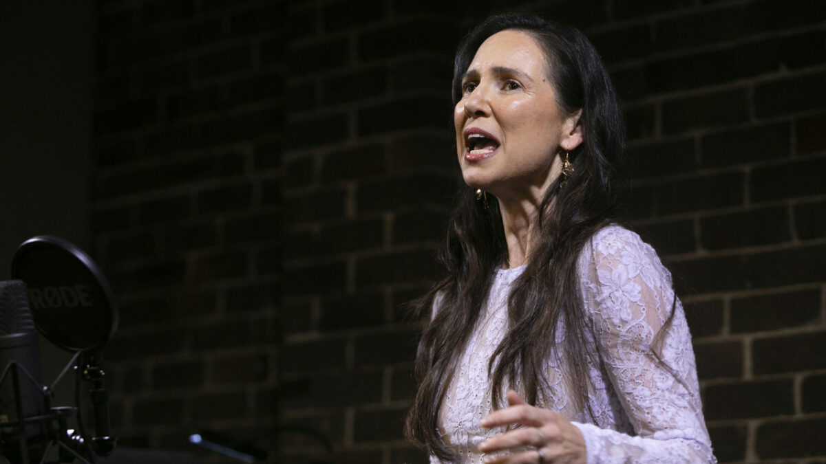 Girl on stage performing Defying Gravity