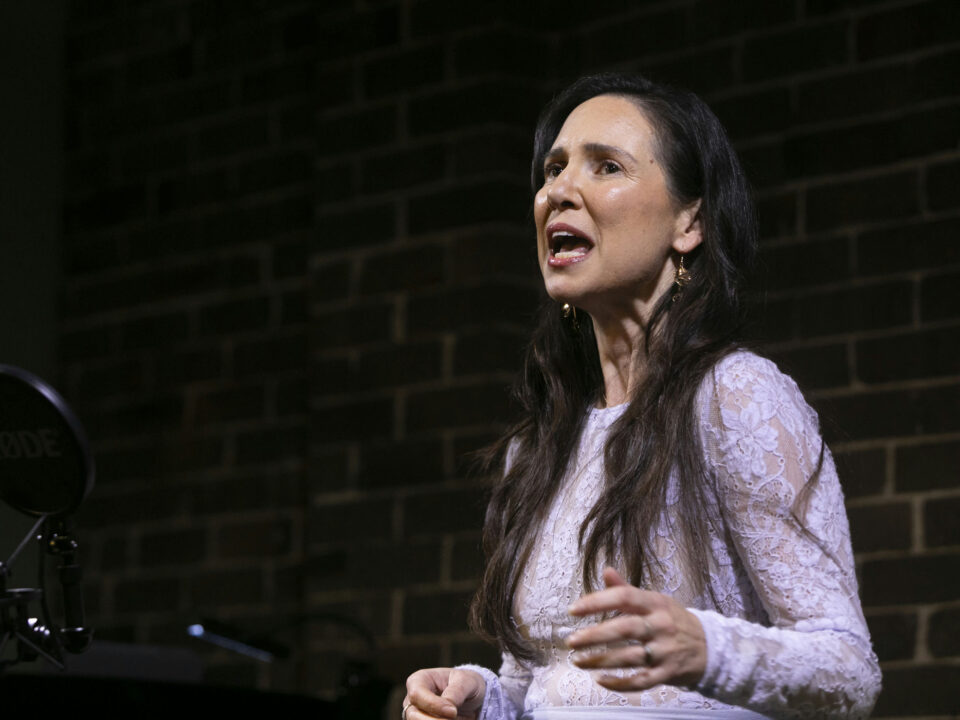 Girl on stage performing Defying Gravity